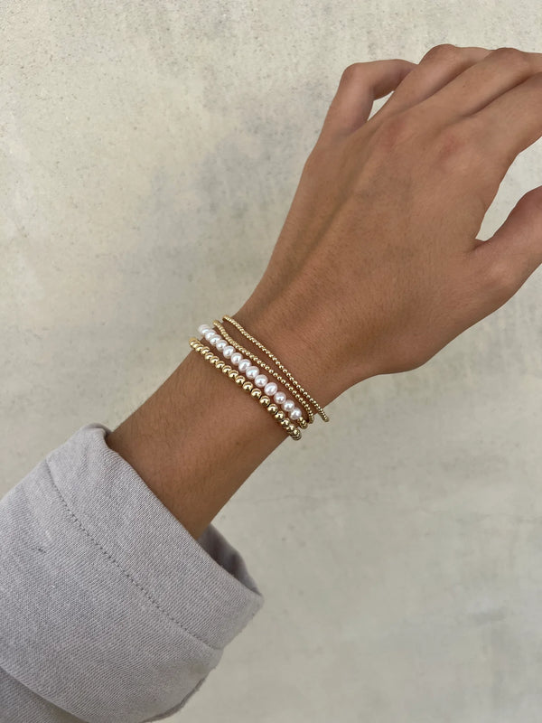 Karen Lazar  - 2 mm Yellow Gold Filled Bead Flex Bracelet with White Pearls Halfway